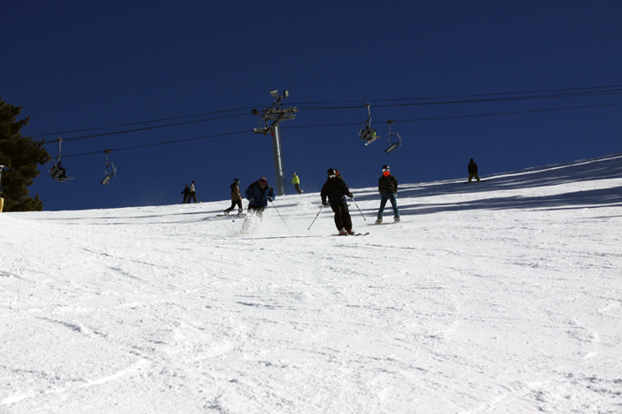 Skiers getting some turns in on one of many great runs.