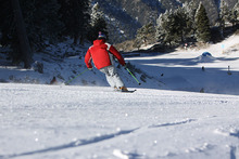 The morning sun glistens off the fresh packed powder.