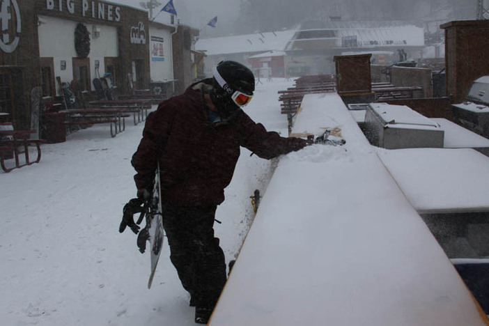 Sweeping the fresh snow off the Big Pines BBQ.