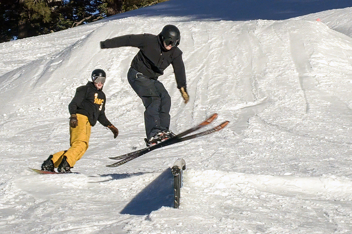 20231207 MHW Chisholm Skier over rail with snowboarder in background.jpg