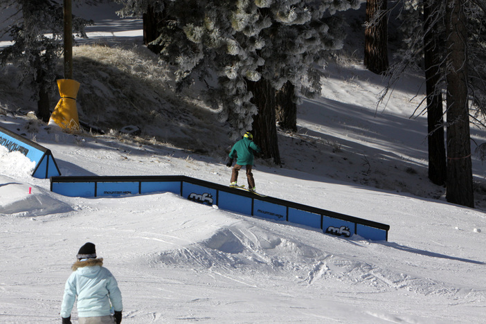 Ski slide on the flat down round rail.