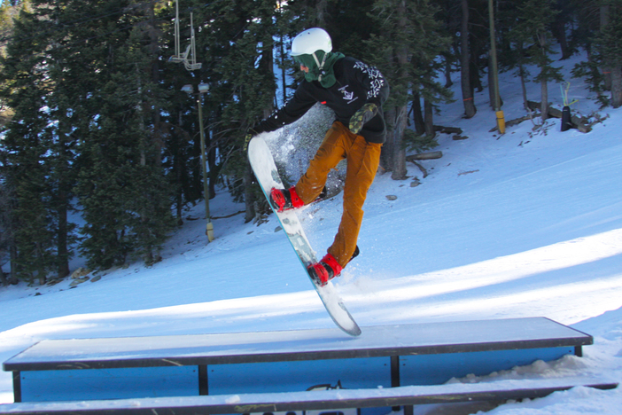 Nose grab over the picnic table.